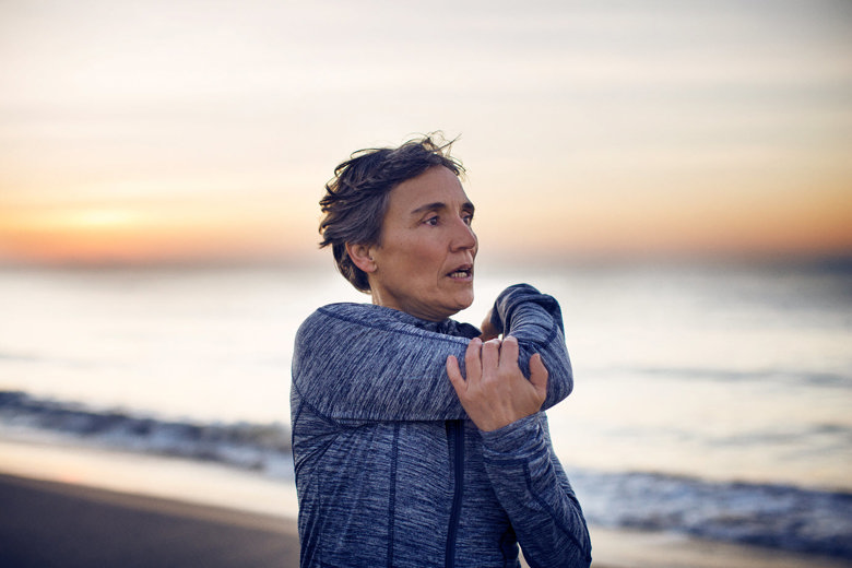 Woman stretching at the beach